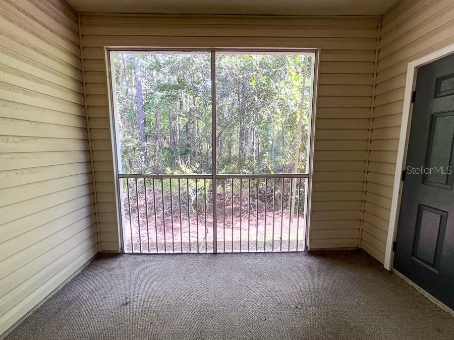 4886 Northwest 46th Place, Unit 106 Gainesville, FL 32606 - Photo 22 of 29 a view of a porch with a wooden floor