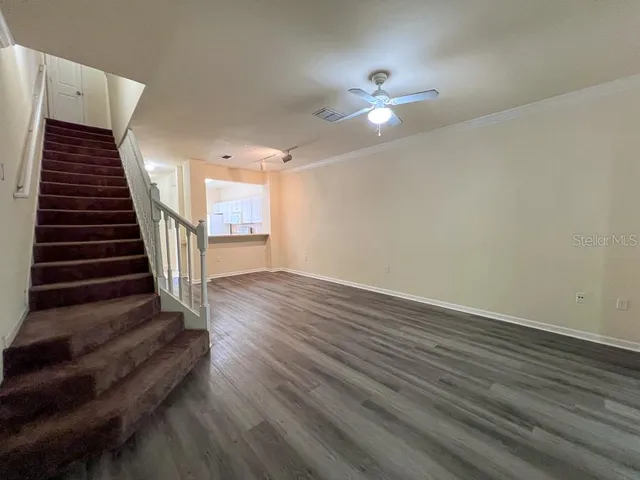 wooden floor in an empty room with a chandelier