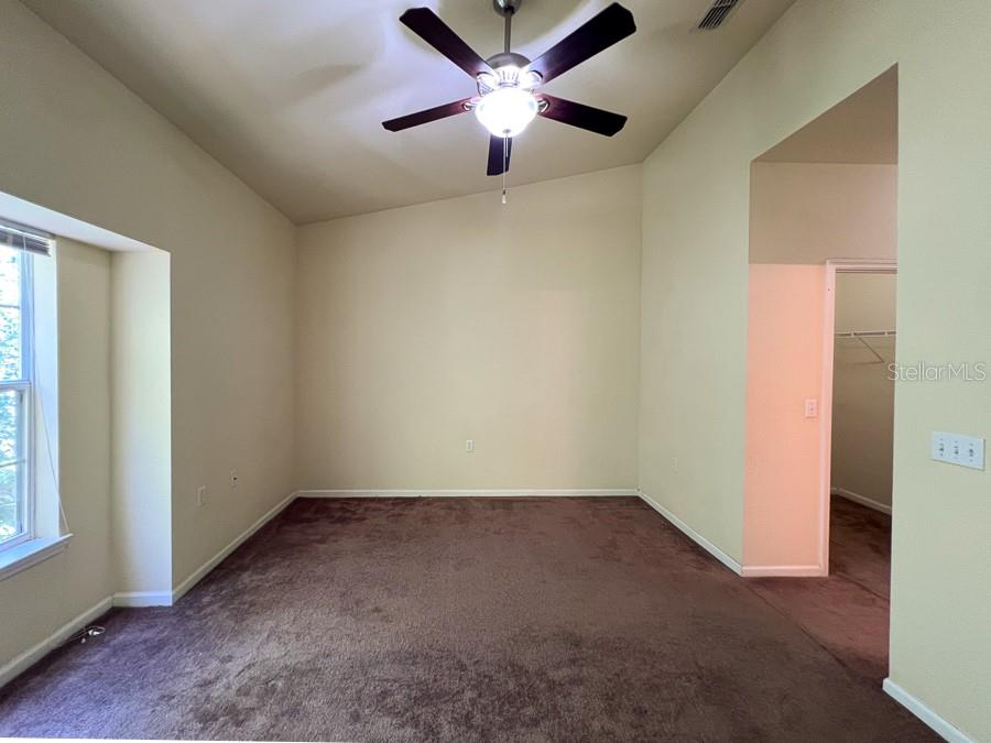 4886 Northwest 46th Place, Unit 106 Gainesville, FL 32606 - Photo 29 of 29 an empty room with a window and a fan