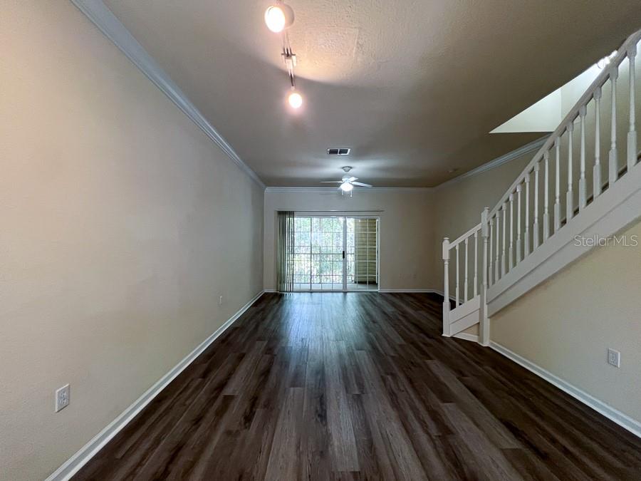 4886 Northwest 46th Place, Unit 106 Gainesville, FL 32606 - Photo 5 of 29 a view of entryway and hall with wooden floor