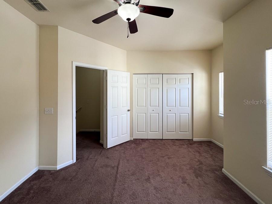 4886 Northwest 46th Place, Unit 106 Gainesville, FL 32606 - Photo 9 of 29 a view of an empty room with chandelier fan