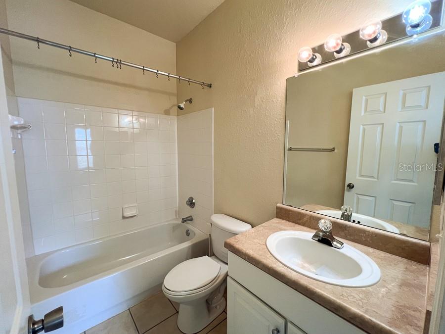 4886 Northwest 46th Place, Unit 106 Gainesville, FL 32606 - Photo 10 of 29 a bathroom with a sink a toilet and shower
