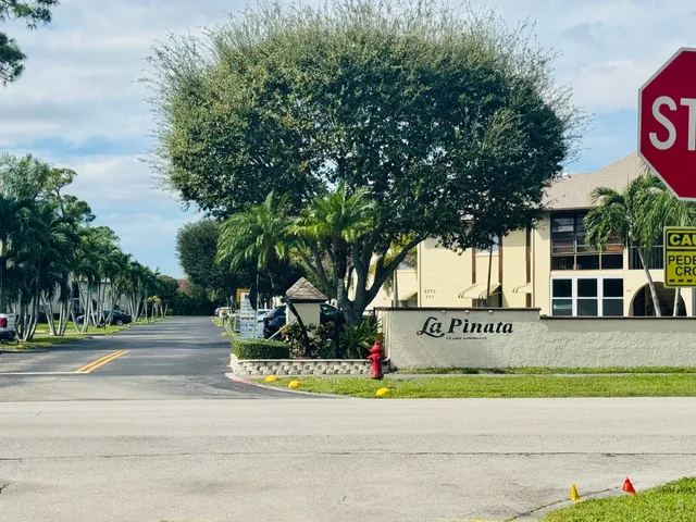 an empty room with mirror and windows