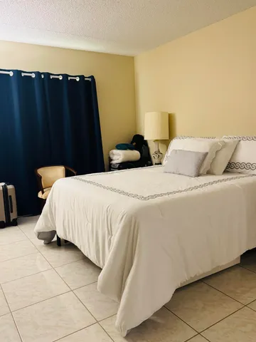 a bed sitting in a bedroom and lamp