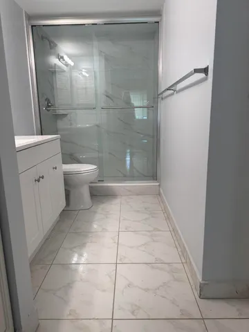 a bathroom with a toilet and a shower