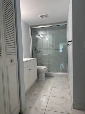 a bathroom with a shower and toilet