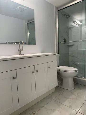a bathroom with a toilet sink and shower
