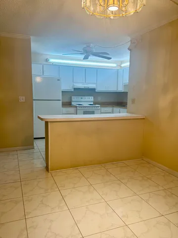a view of kitchen with stainless steel appliances cabinets