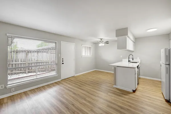 a room with a hardwood floor and a window