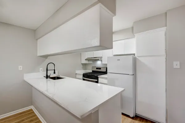 a kitchen with a sink a stove and refrigerator