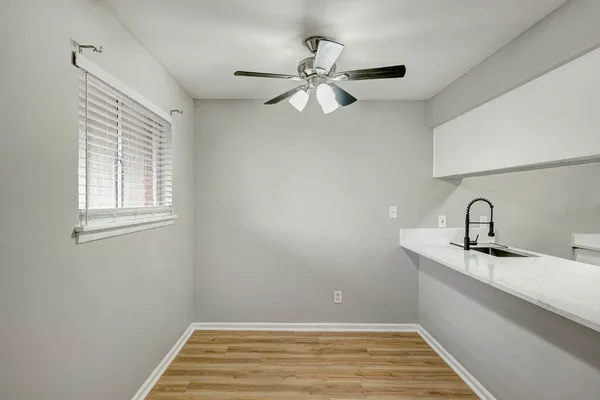 a view of a kitchen with a sink and chandelier fan