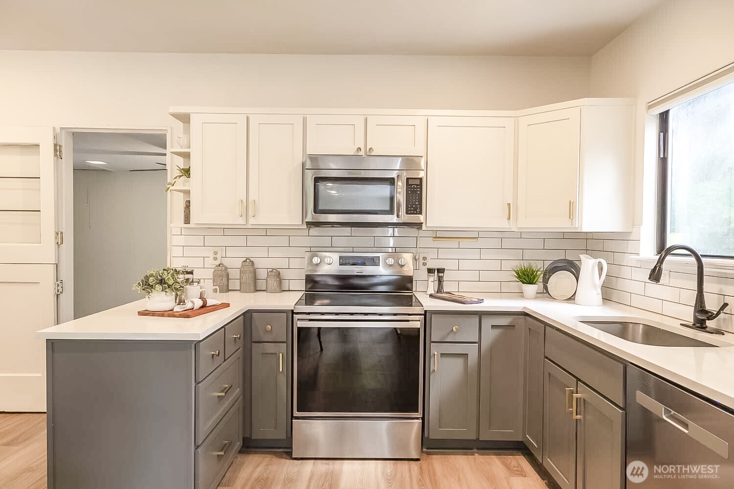 912 Northeast 115th Street Seattle, WA 98125 - Photo 7 of 21 a kitchen with a sink stove and microwave