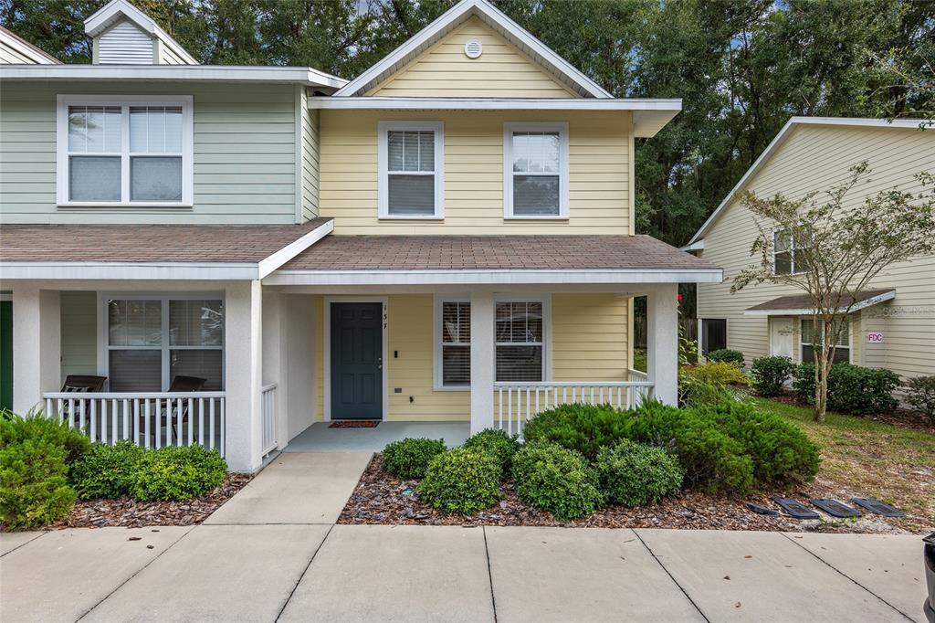 4663 Southwest 48th Drive, Unit 137 Gainesville, FL 32608 - Photo 1 of 1 a front view of a house with garden