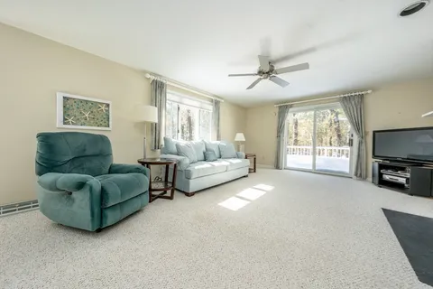 a living room with couches and a flat screen tv