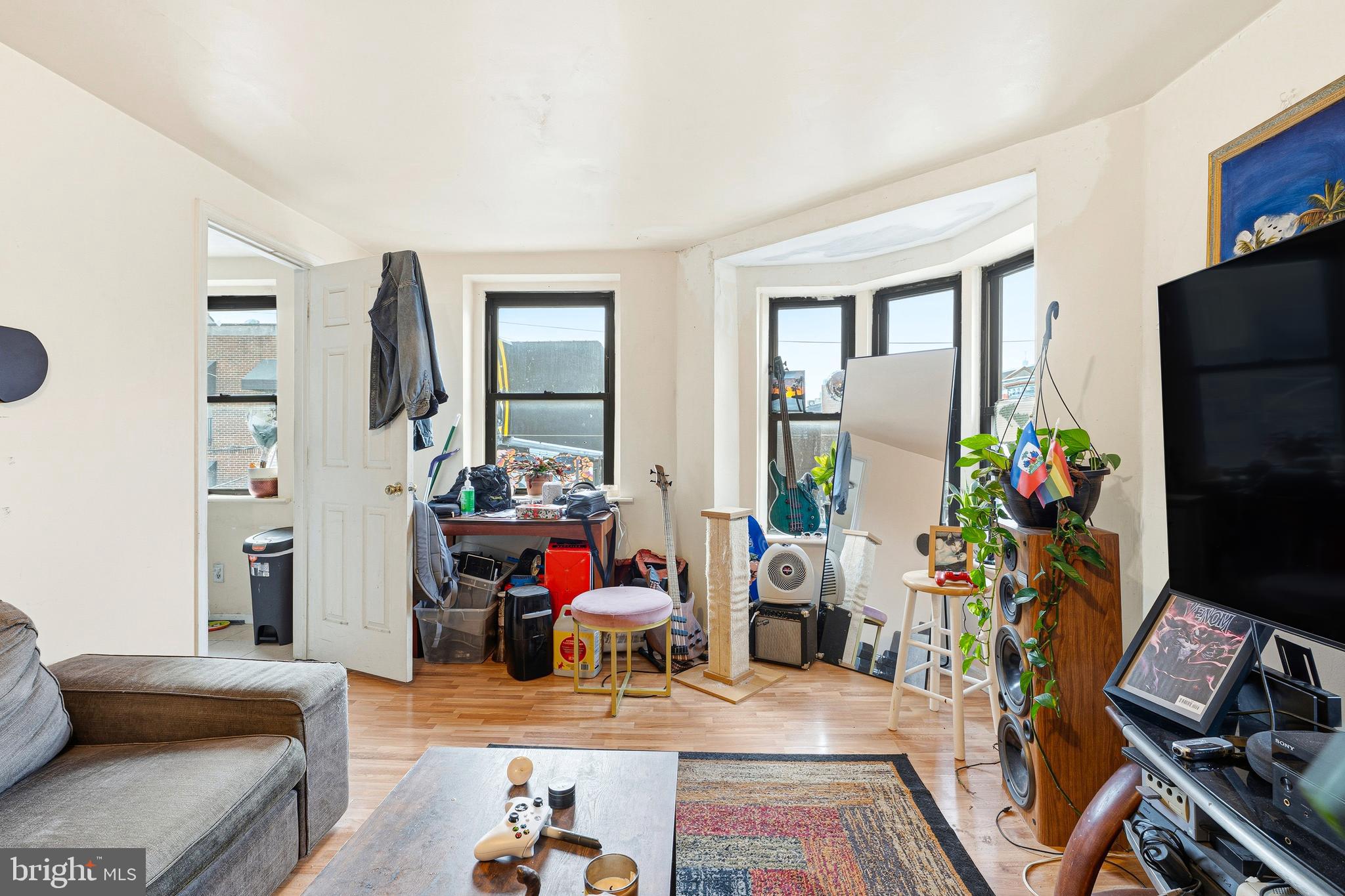 252-254 South Street, Unit 3 Philadelphia, PA 19147 - Photo 3 of 13 a living room with furniture a flat screen tv and a table
