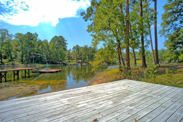 a living room with furniture a flat screen tv and a table