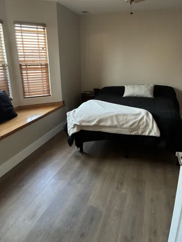 a bedroom with a bed and a window