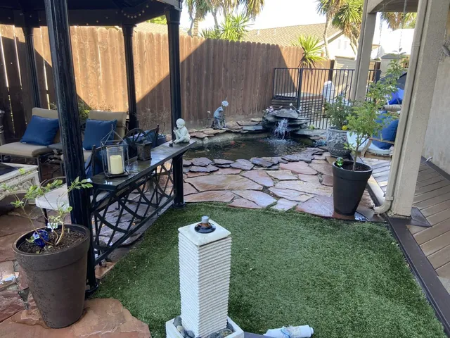 a view of a chair and table in backyard
