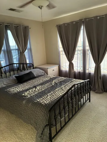a living room with furniture ceiling fan and a window
