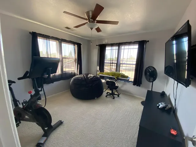 a bedroom with a bed furniture and a flat screen tv