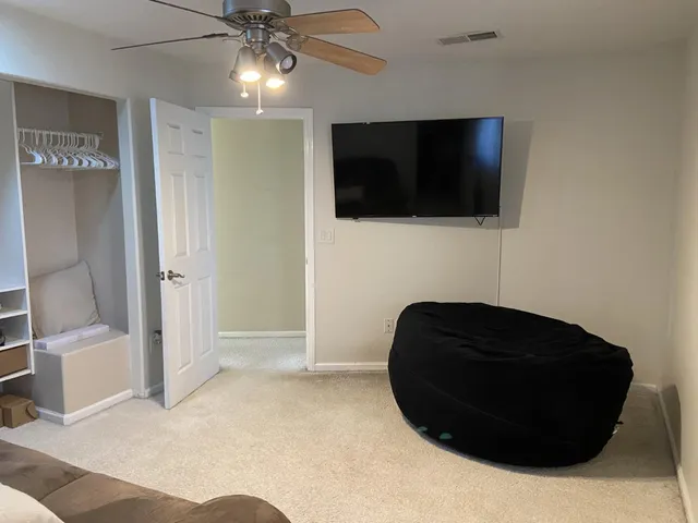 a view of a livingroom with furniture and flat screen tv