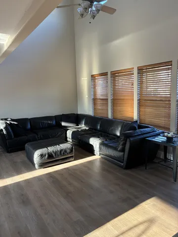 a living room with furniture flat screen tv and a window