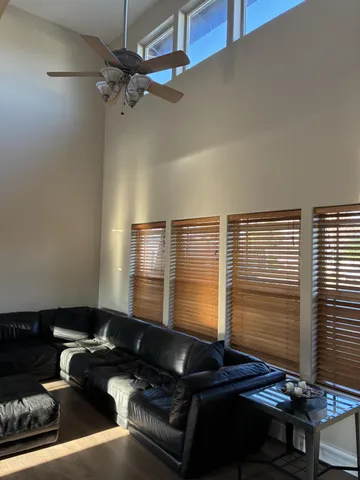 a blue room with wooden floor and a window