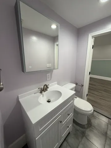 a bathroom with a sink toilet and mirror