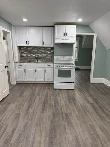 a kitchen with stainless steel appliances a stove a refrigerator and cabinets