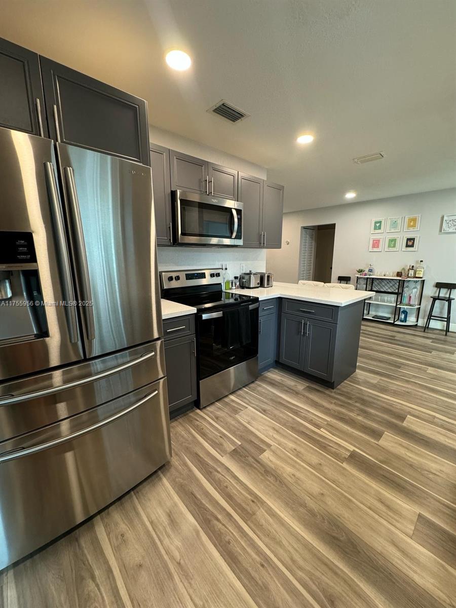 4161 Southwest 56th Avenue Davie, FL 33314 - Photo 12 of 40 a kitchen with stainless steel appliances granite countertop a refrigerator a stove top oven a sink and dishwasher