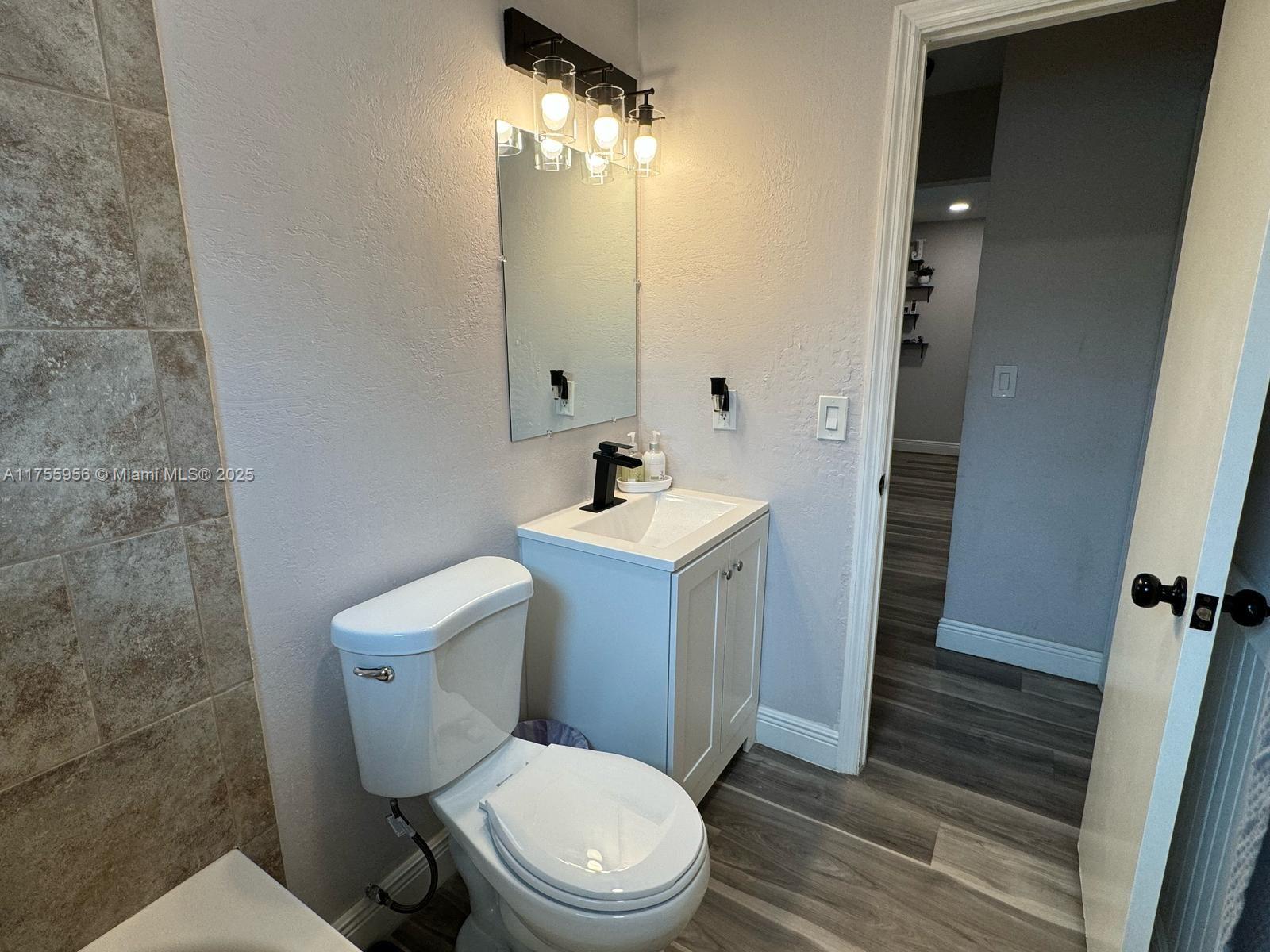 4161 Southwest 56th Avenue Davie, FL 33314 - Photo 23 of 40 a white toilet sitting next to a bathroom sink
