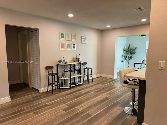 a kitchen with stainless steel appliances granite countertop a refrigerator a stove top oven a sink and dishwasher