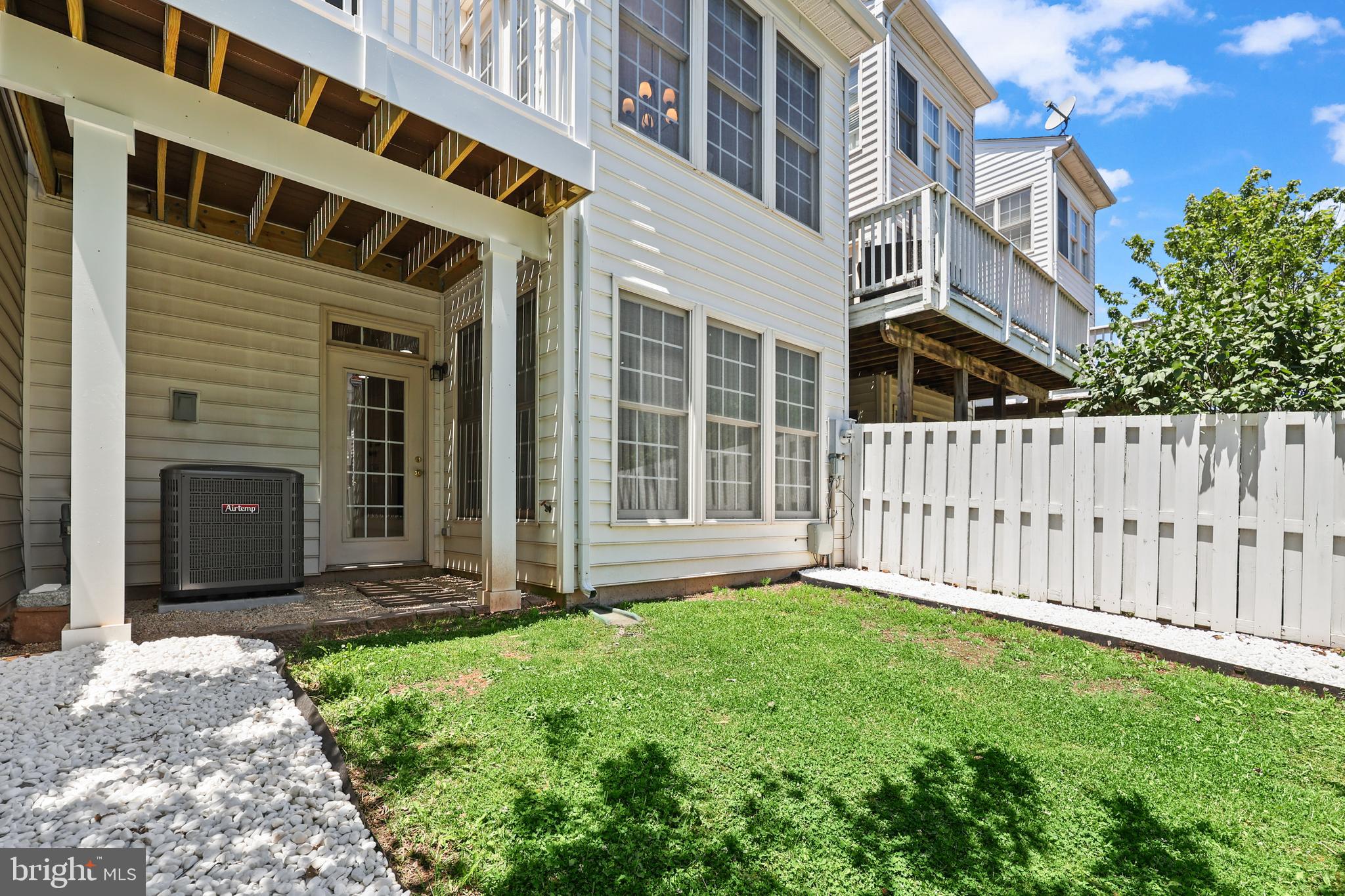 6806 Witton Circle Gainesville, VA 20155 - Photo 34 of 47 a view of a house with a small yard and wooden fence
