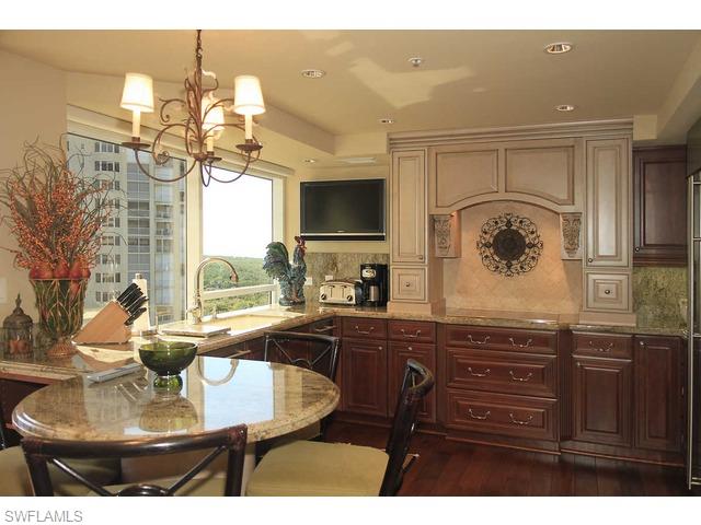 6825 Grenadier Boulevard Naples, FL 34108 - Photo 7 of 11 a kitchen with a table and chairs