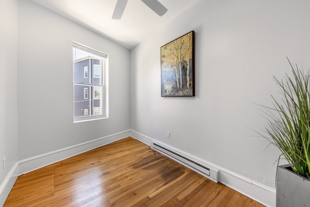 113 Regent Street Boston, MA 02119 - Photo 14 of 18 a room with a window and wooden floor