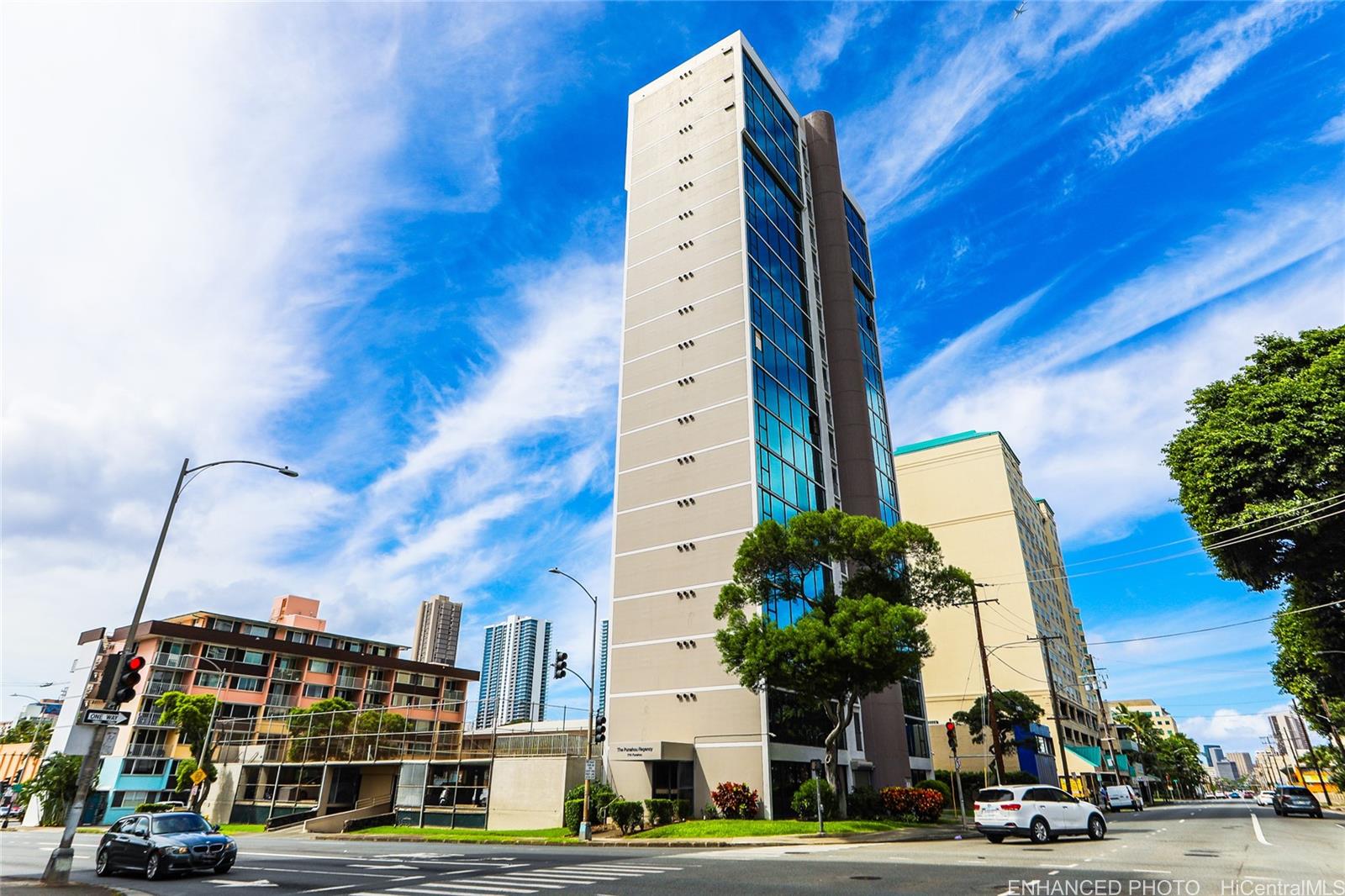 a view of a tall building next to a road