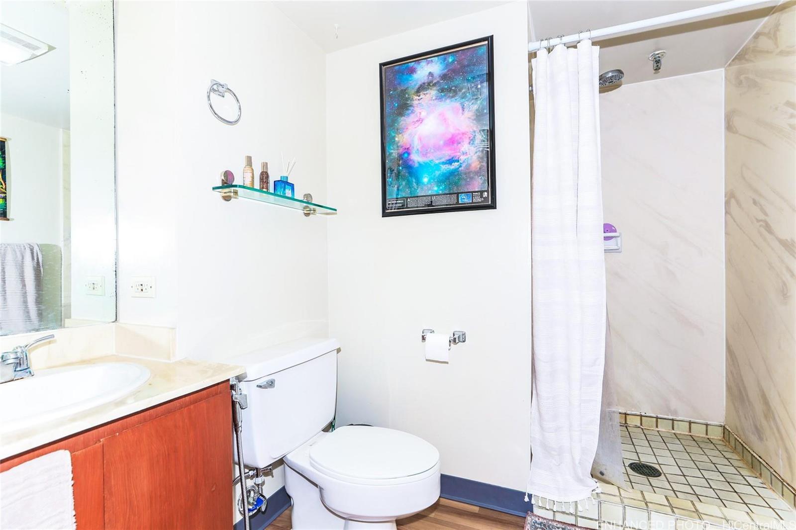 1114 Punahou Street, Unit 3B Honolulu, HI 96826 - Photo 12 of 25 a white toilet sitting next to a bathroom sink