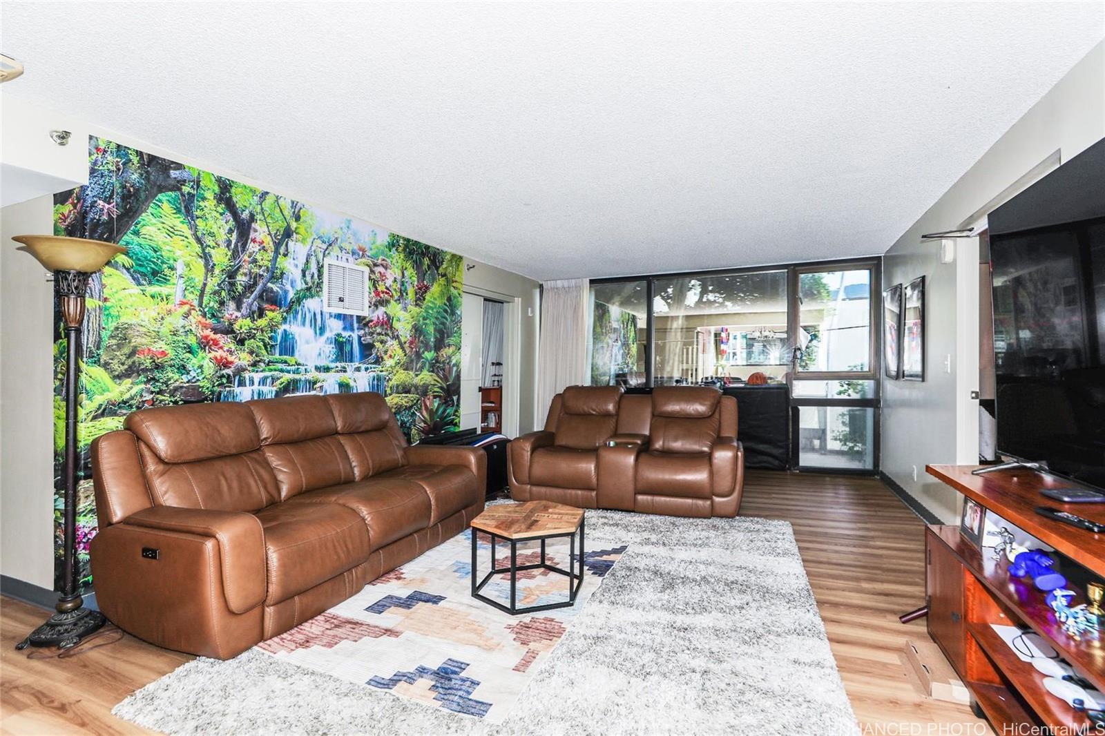 1114 Punahou Street, Unit 3B Honolulu, HI 96826 - Photo 2 of 25 a living room with furniture and a flat screen tv