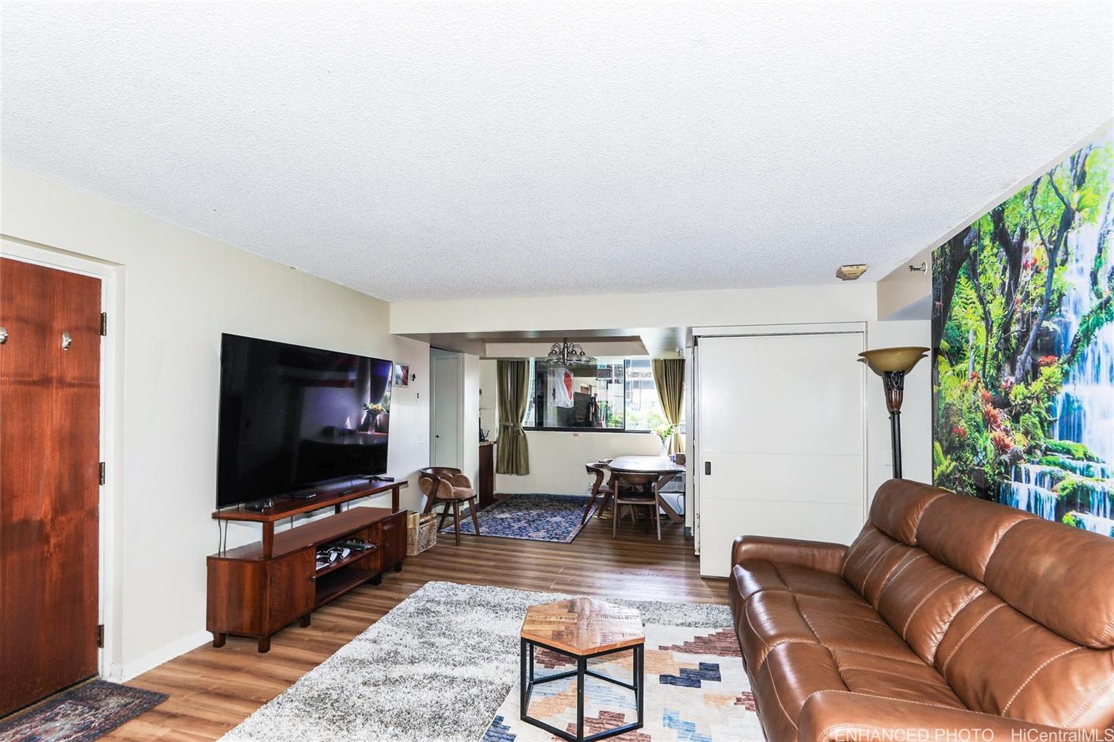 1114 Punahou Street, Unit 3B Honolulu, HI 96826 - Photo 5 of 25 a living room with furniture and a flat screen tv