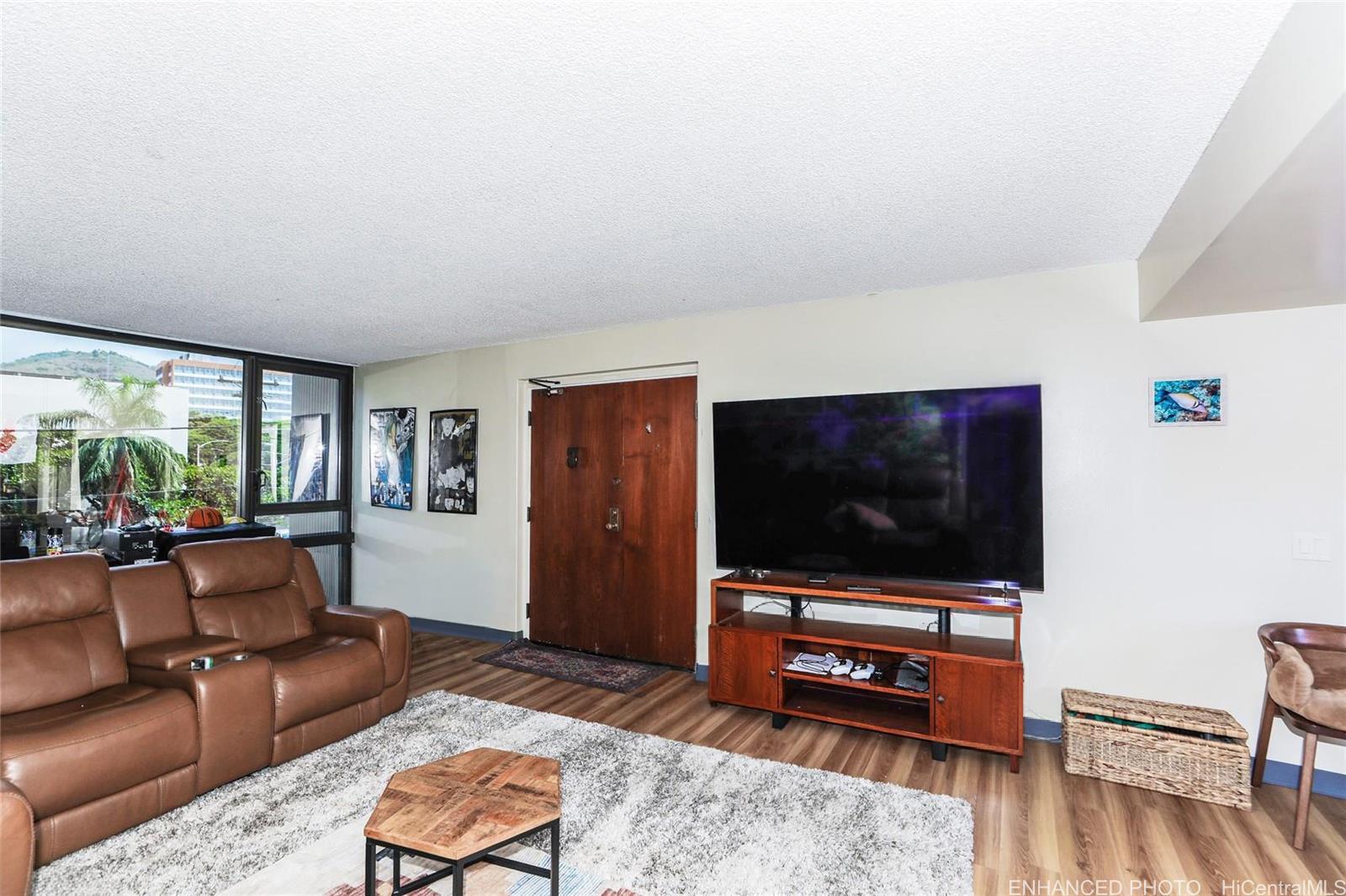 1114 Punahou Street, Unit 3B Honolulu, HI 96826 - Photo 6 of 25 a living room with furniture and a flat screen tv