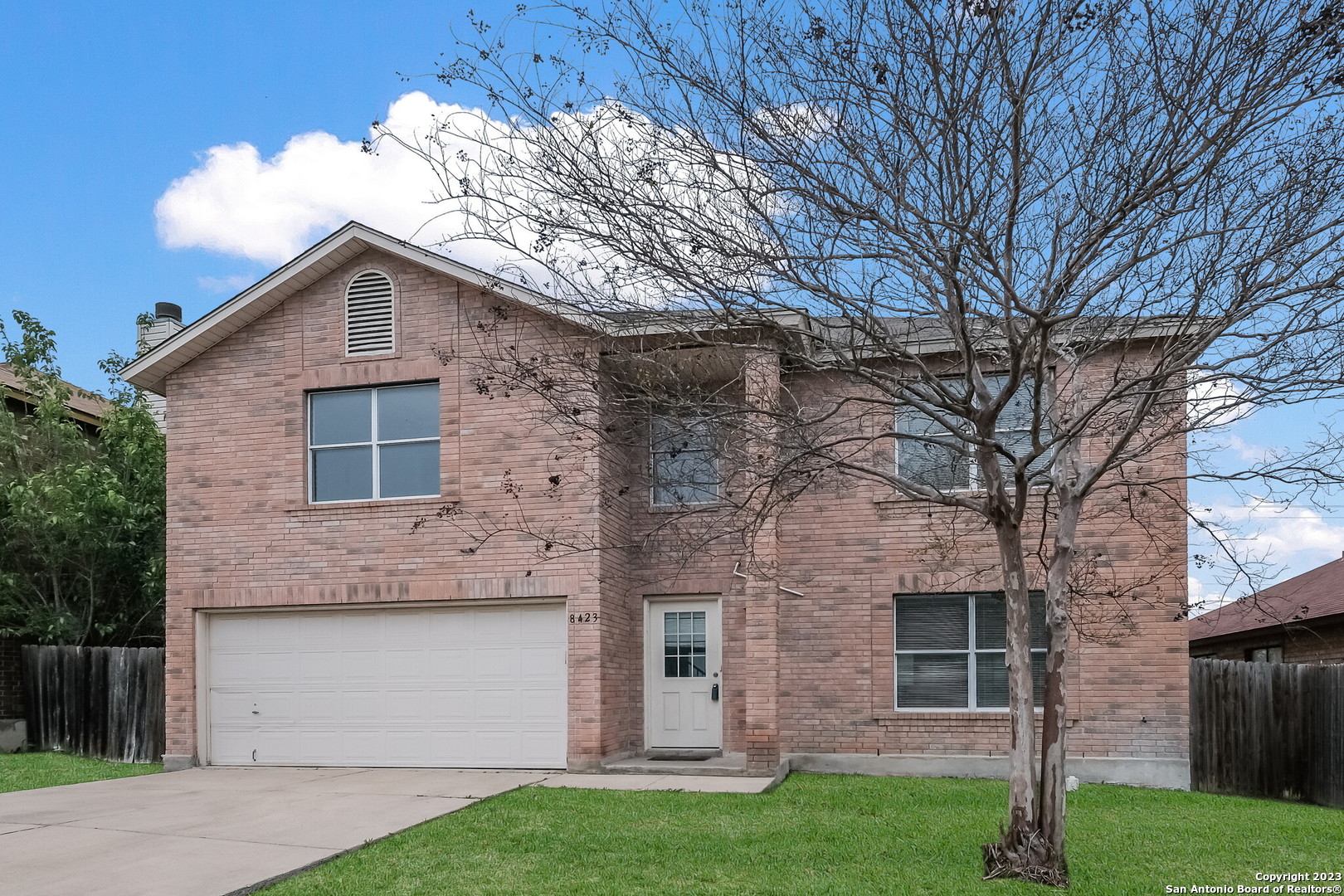 a view of a house with a yard