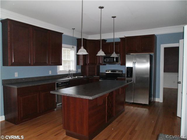 11811 Reedy Branch Road Chesterfield, VA 23838 - Photo 2 of 5 a kitchen with stainless steel appliances granite countertop a sink a microwave a refrigerator and wooden floor