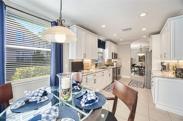 a kitchen with stainless steel appliances granite countertop wooden floor dining table and chairs