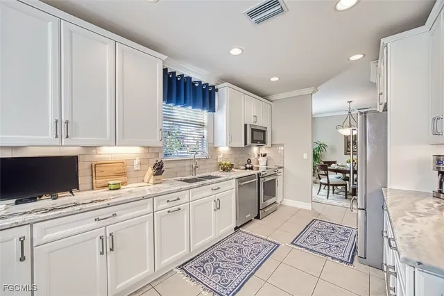 a kitchen with a sink window and cabinets