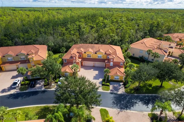 an aerial view of a house with a garden and yard