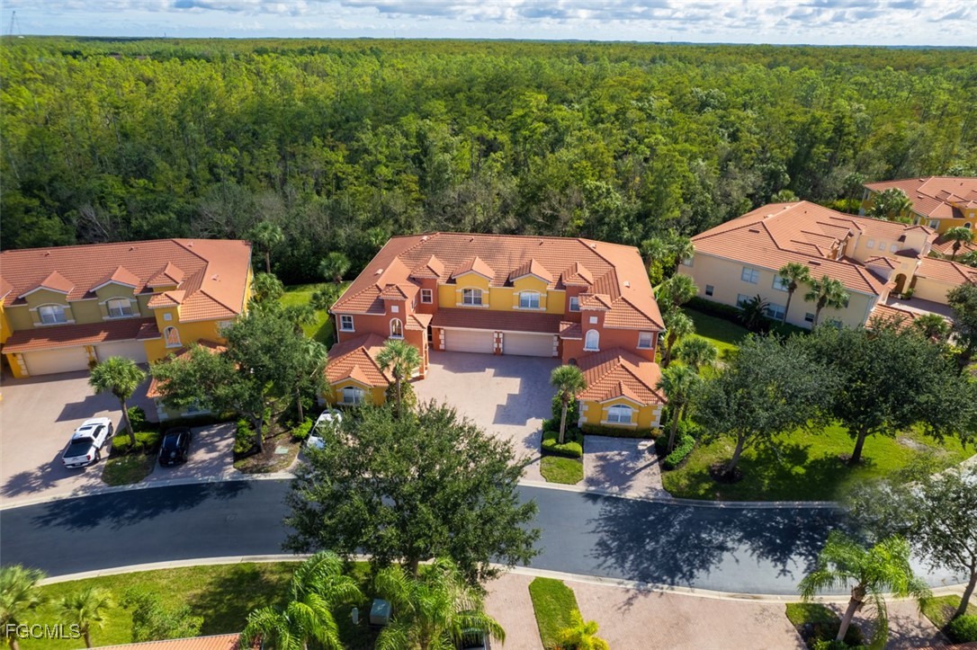12129 Lucca Street, Unit 102 Fort Myers, FL 33966 - Photo 2 of 40 an aerial view of a house with a garden and yard