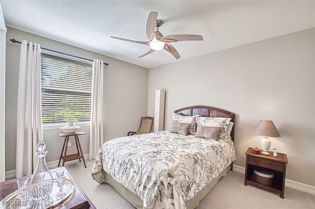 12129 Lucca Street, Unit 102 Fort Myers, FL 33966 - Photo 23 of 40 a bedroom with a bed and a window