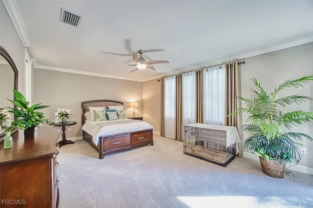 a spacious bedroom with a large bed and a chandelier
