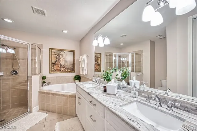 a bathroom with a granite countertop sink mirror and bathtub