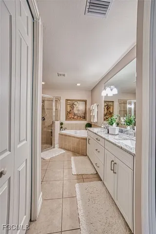 a large white kitchen with cabinets and furniture